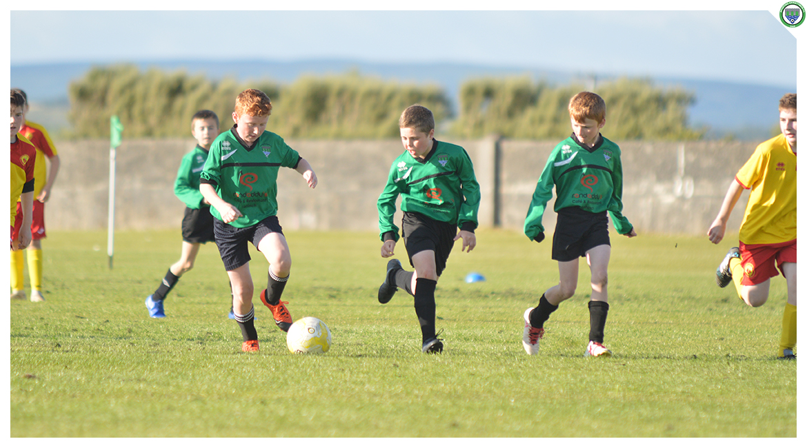 John O'Brien carries the ball forward in the U12 game between Sporting Ennistymon Football Club and Avenue United Football Club. Game played in Lahinch Sportsfield on the 11th of June 2019.