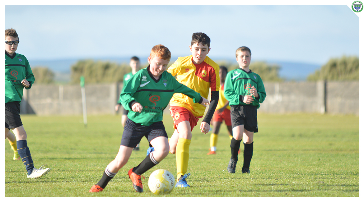 John O'Brien dribbles past an opponent in the U12 game between Sporting Ennistymon Football Club and Avenue United Football Club. Game played in Lahinch Sportsfield on the 11th of June 2019.