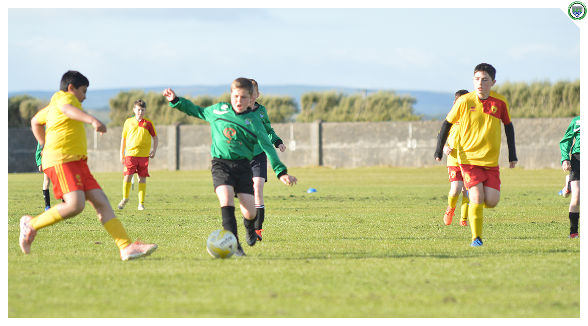 Daniel Brody competes for the ball with an Avenue United opponent in the U12 game between Sporting Ennistymon Football Club and Avenue United Football Club. Game played in Lahinch Sportsfield on the 11th of June 2019.