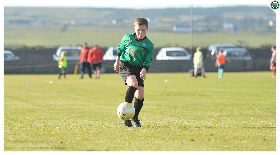 Daniel Brody receiving a pass in the U12 game between Sporting Ennistymon Football Club and Avenue United Football Club. Game played in Lahinch Sportsfield on the 11th of June 2019.