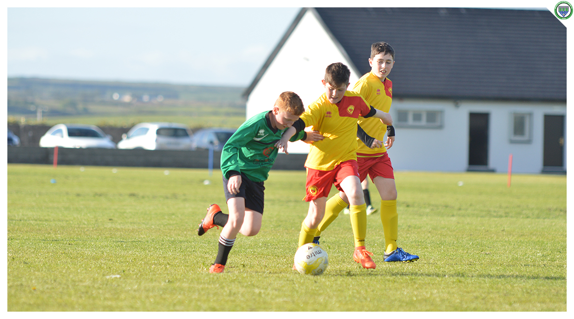 John O'Brien challenges with an Avenue United player for possession in the U12 game between Sporting Ennistymon Football Club and Avenue United Football Club. Game played in Lahinch Sportsfield on the 11th of June 2019.