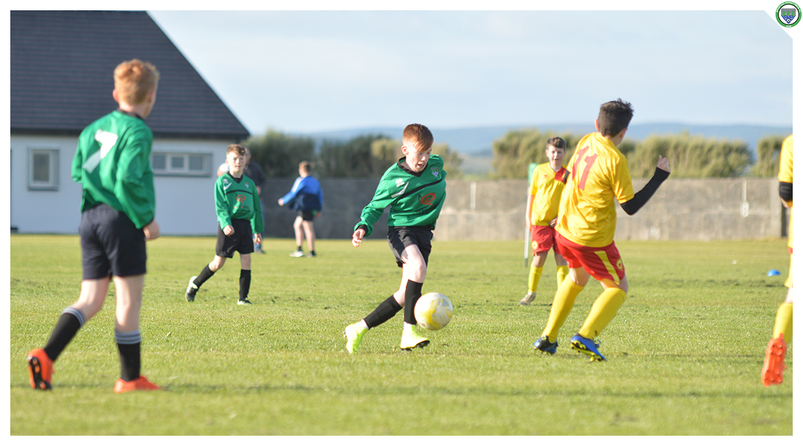Eoin Devanney dribbles past an Avenue United player in the U12 game between Sporting Ennistymon Football Club and Avenue United Football Club. Game played in Lahinch Sportsfield on the 11th of June 2019.