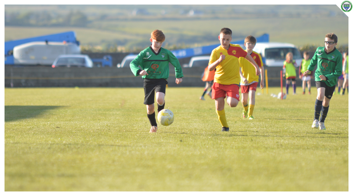 Darragh Cassidy dribbles down the line in the U12 game between Sporting Ennistymon Football Club and Avenue United Football Club. Game played in Lahinch Sportsfield on the 11th of June 2019.