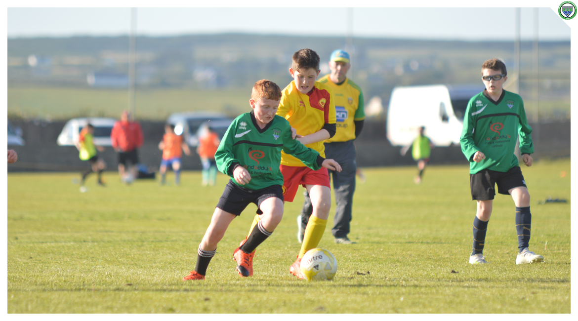 John O'Brien beats an Avenue United player in the U12 game between Sporting Ennistymon Football Club and Avenue United Football Club. Game played in Lahinch Sportsfield on the 11th of June 2019.