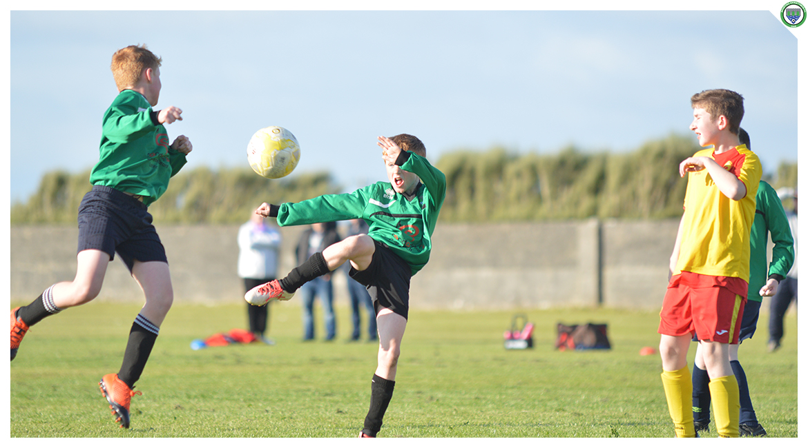 Darren O'Brien attempts to volley the ball in the U12 game between Sporting Ennistymon Football Club and Avenue United Football Club. Game played in Lahinch Sportsfield on the 11th of June 2019.