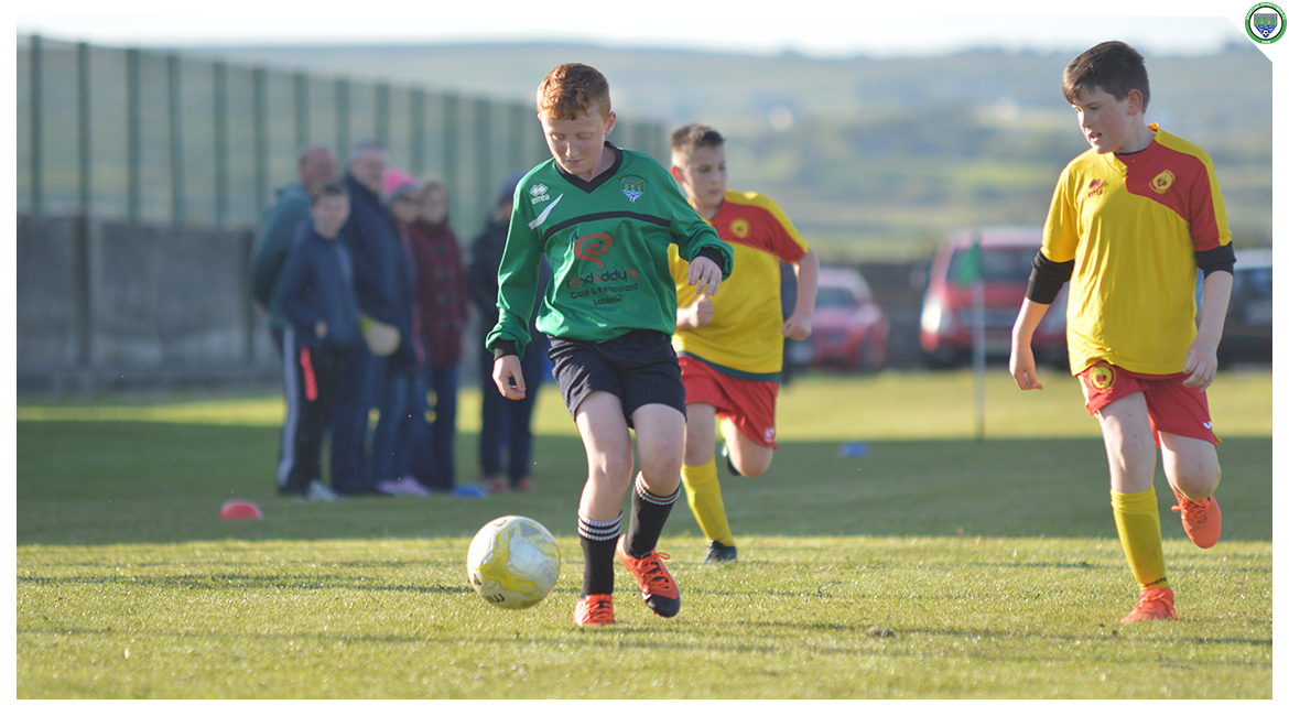 John O'Brien dribbles along the touchline in the U12 game between Sporting Ennistymon Football Club and Avenue United Football Club. Game played in Lahinch Sportsfield on the 11th of June 2019.