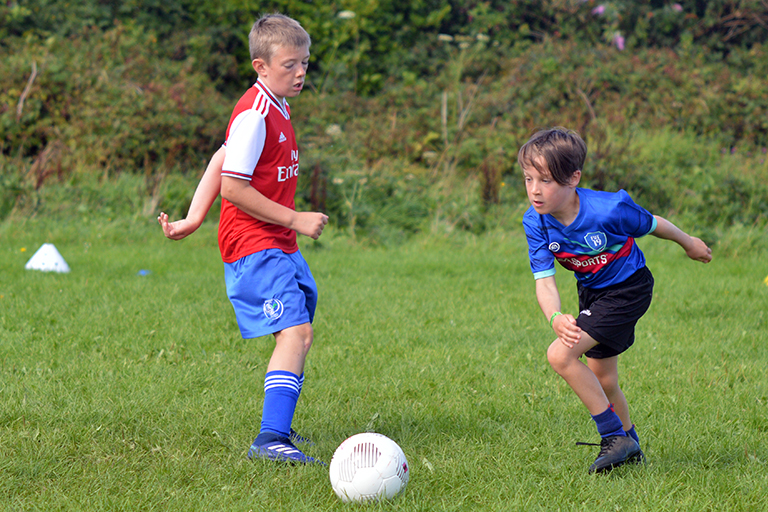 Thomas Slavin in action against Killian O'Neil during the Sporting Ennistymon F.C F.A.I Summer Camp 2020