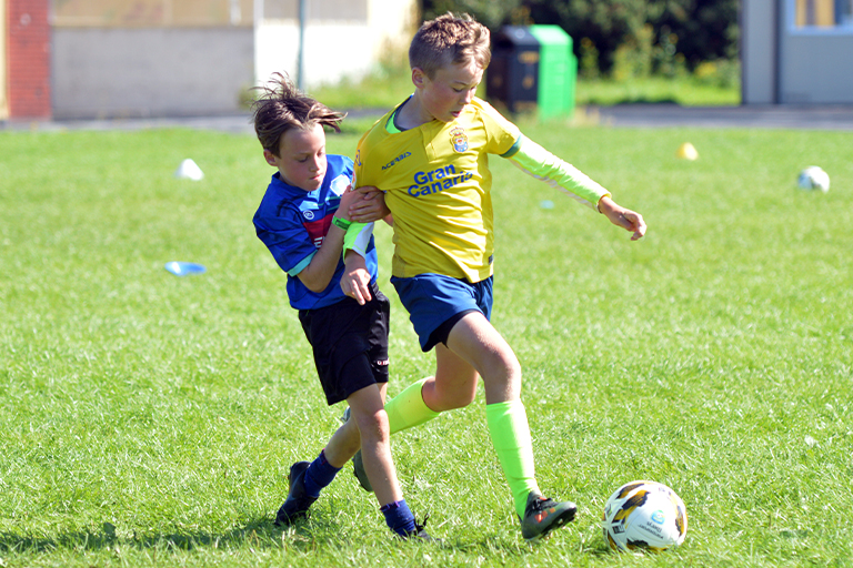 Liam Flynn and Thomas Slavin in action during Sporting Ennistymon F.C FAI Summer Camp 2020