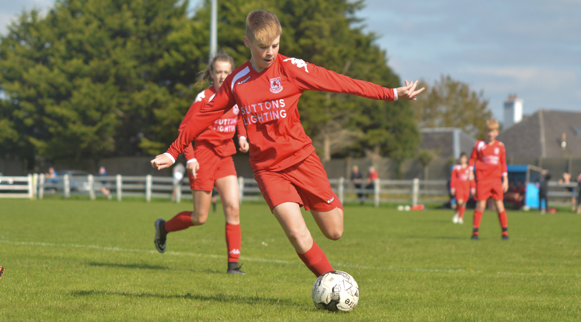 A Lifford AFC player clears the ball over the sideline in the U13 Division 2 Cup Final between Sporting Ennistymon F.C and Lifford A.F.C in Frank Healy Park.
