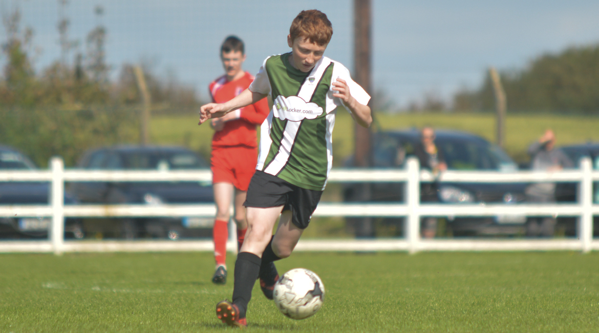 John O'Brien wins possesion in the U13 Division 2 Cup Final between Sporting Ennistymon F.C and Lifford A.F.C in Frank Healy Park.