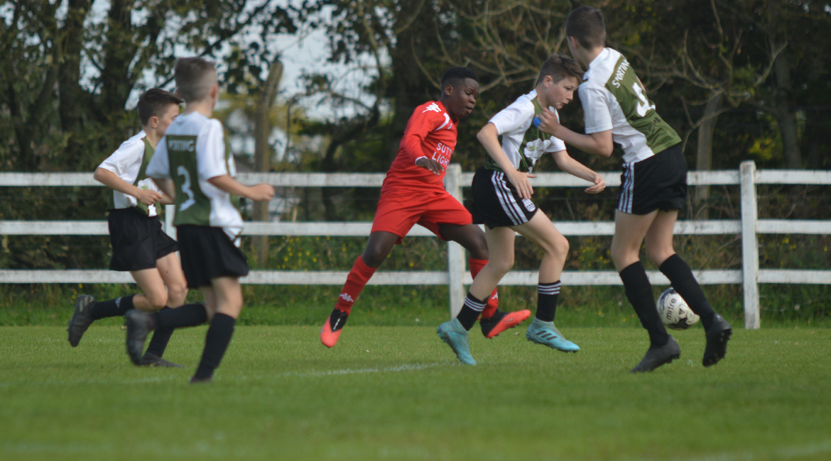 A Lifford AFC player looks to shoot but his effort is blocked by Louis Griffin during the U13 Division 2 Cup Final between Sporting Ennistymon F.C and Lifford A.F.C in Frank Healy Park.