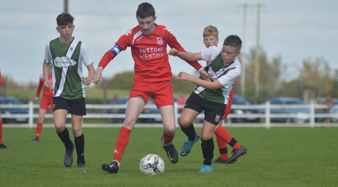 Daniel Brody battles for possession during the U13 Division 2 Cup Final between Sporting Ennistymon F.C and Lifford A.F.C in Frank Healy Park.