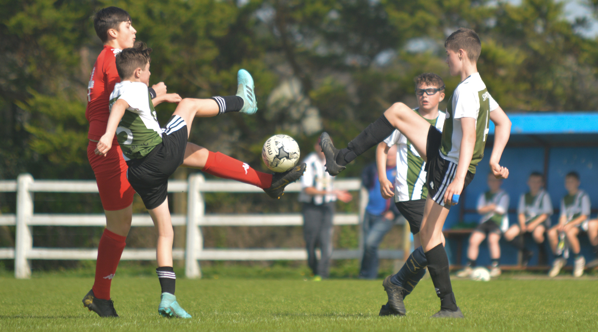 Louis Griffin, Jack Gallagher and a Lifford AFC player challenge for possession during the U13 Division 2 Cup Final between Sporting Ennistymon F.C and Lifford A.F.C in Frank Healy Park.